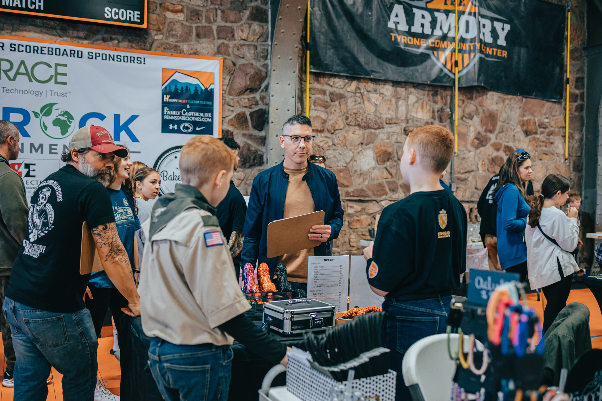 A judge with a clipboard visiting booths at the Tyrone Armory Community Center