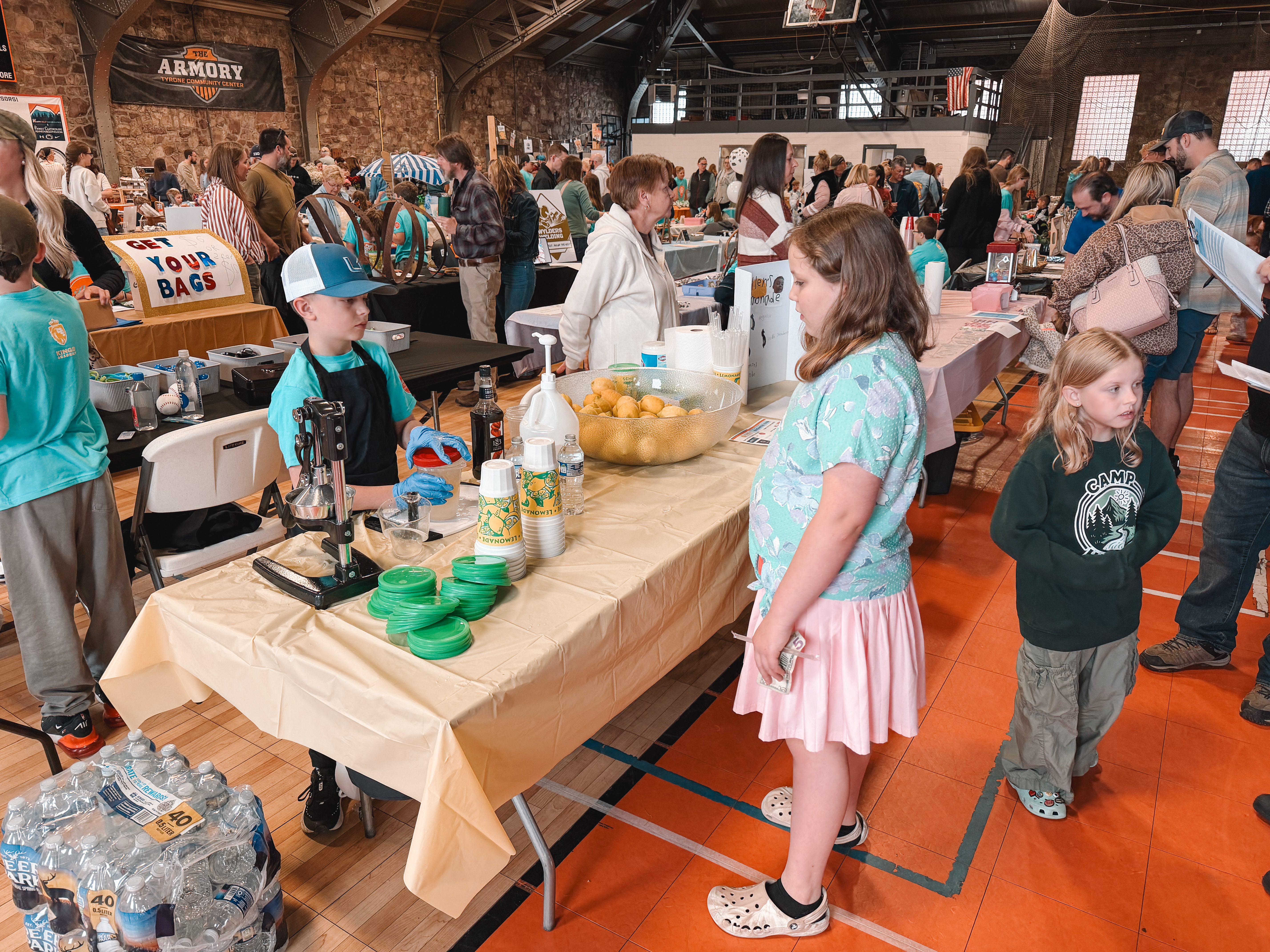 A young entrepreneur fresh-squeezing lemonade for customers