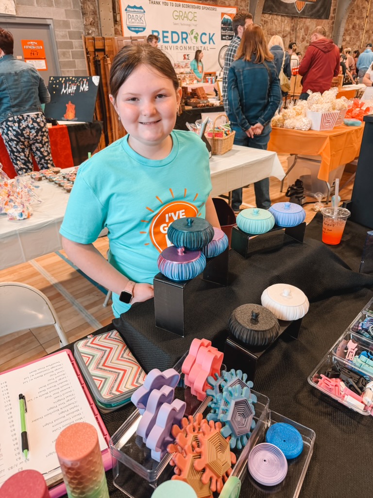 A Lion selling handmade pottery and fidgets