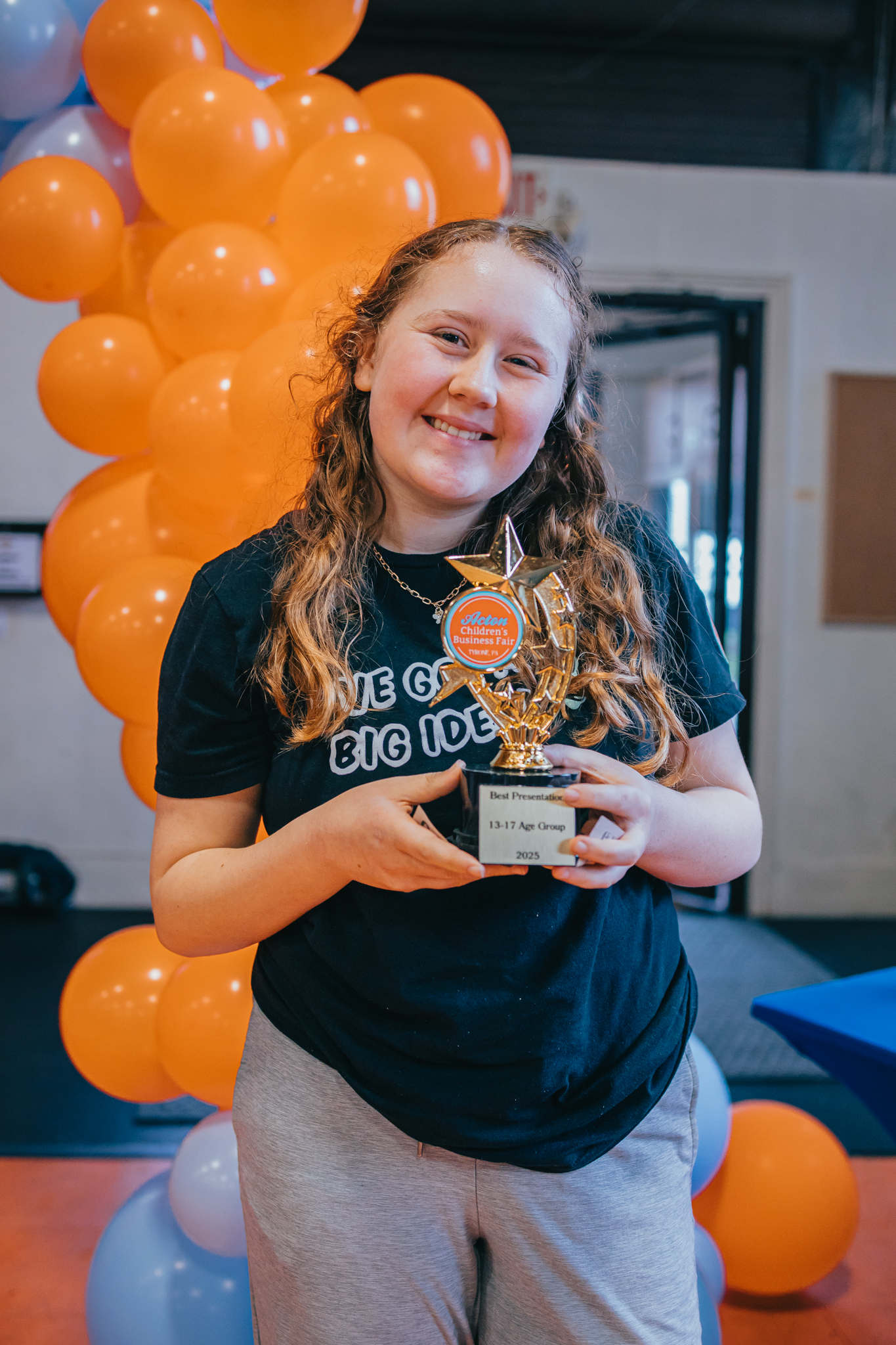 A Best Presentation winner proudly holding her trophy