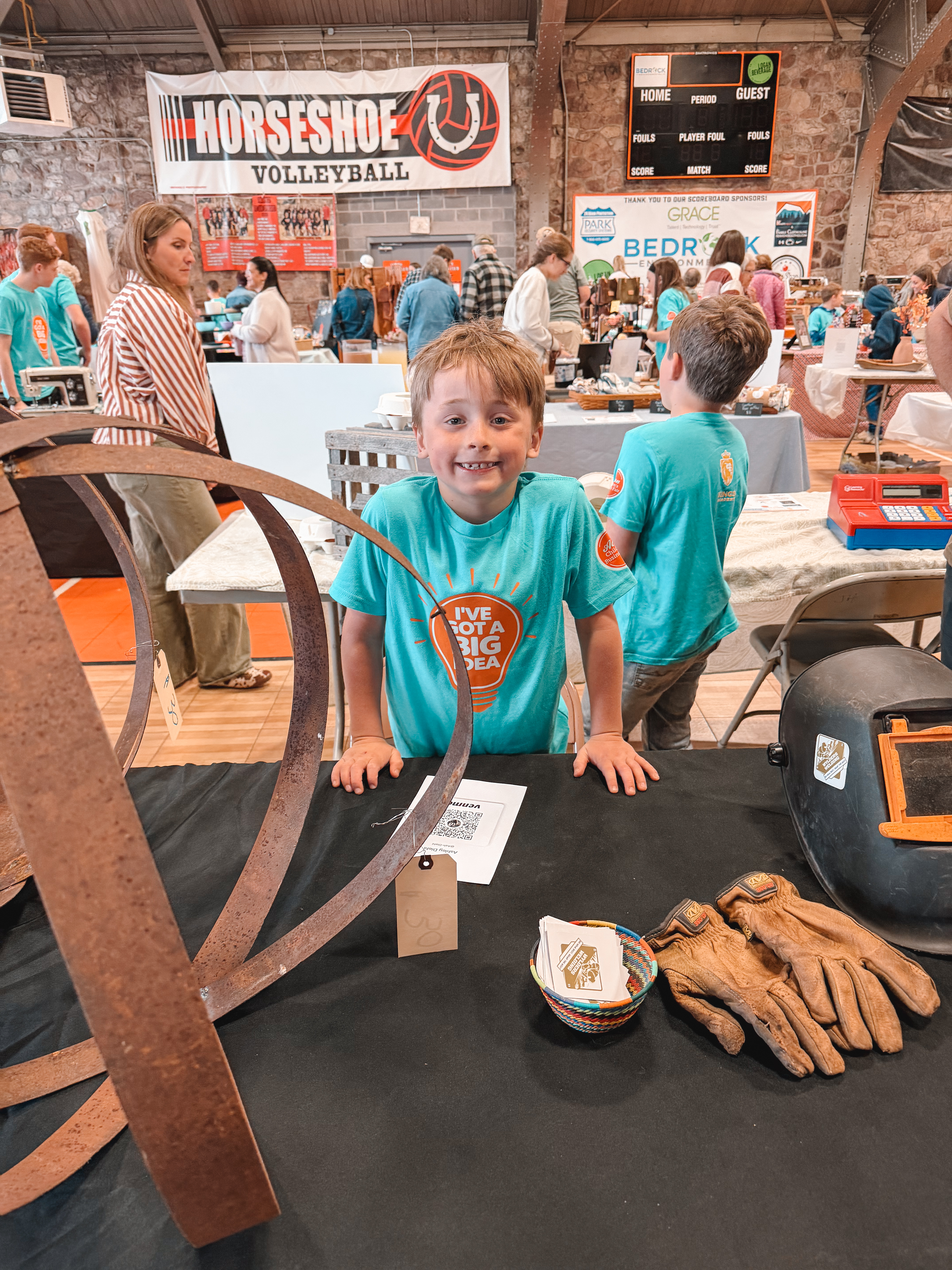 A young welder proudly showing his metalwork