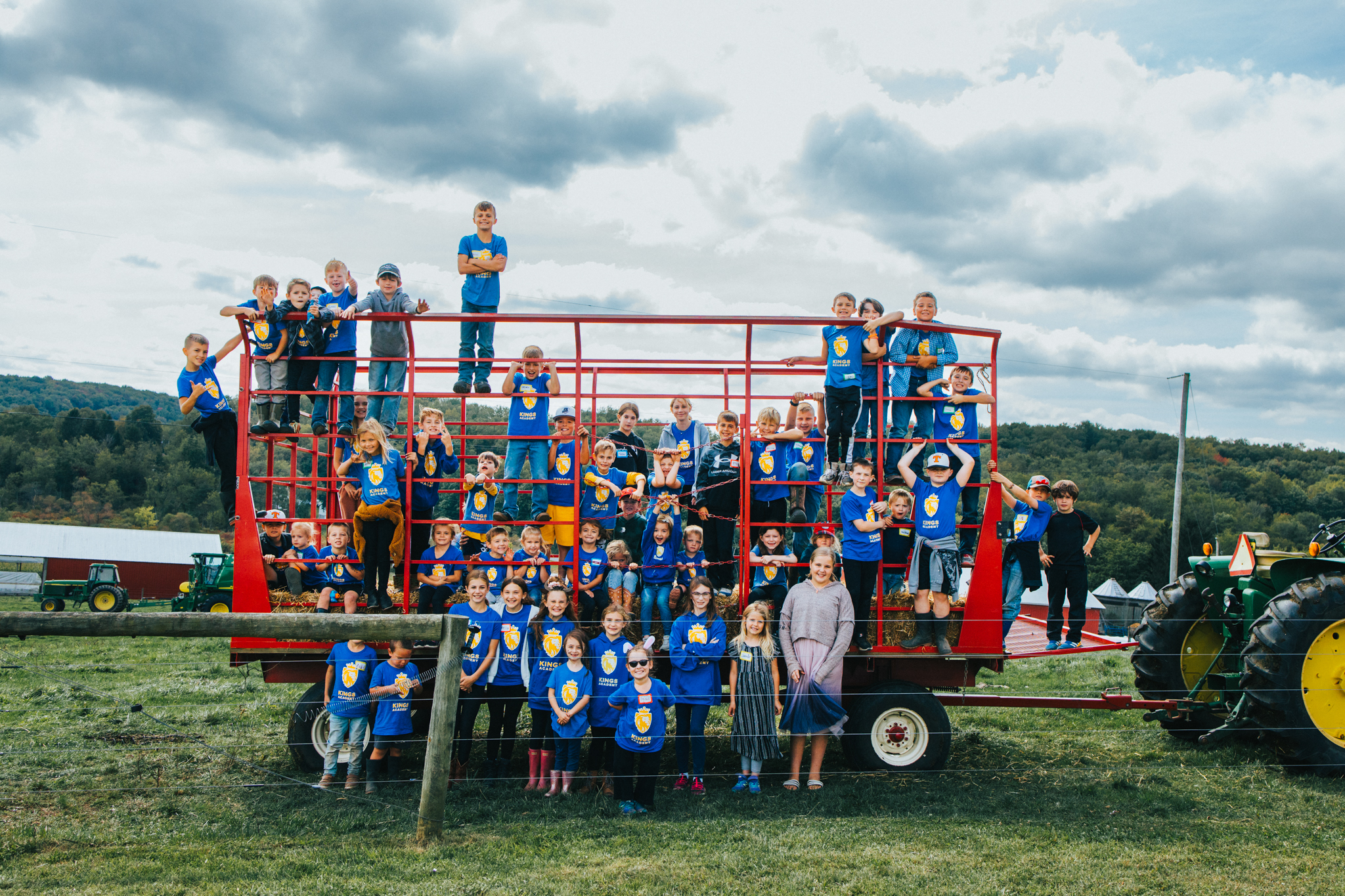 The Kings Academy tribe together on a hay wagon