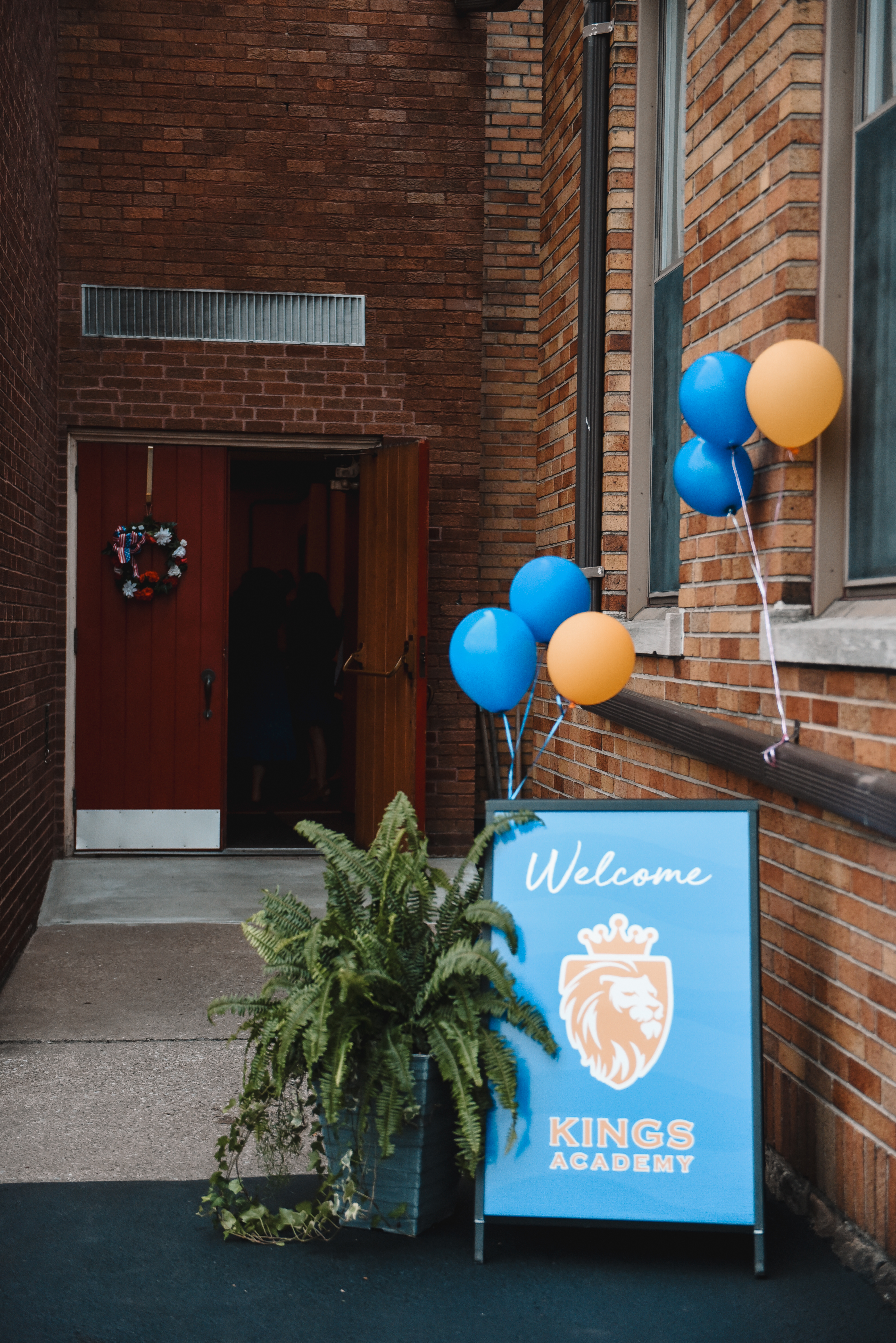 The Kings Academy welcome sign and balloons at the front door